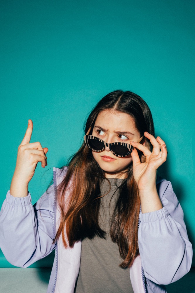Elena adjusting her sunglasses