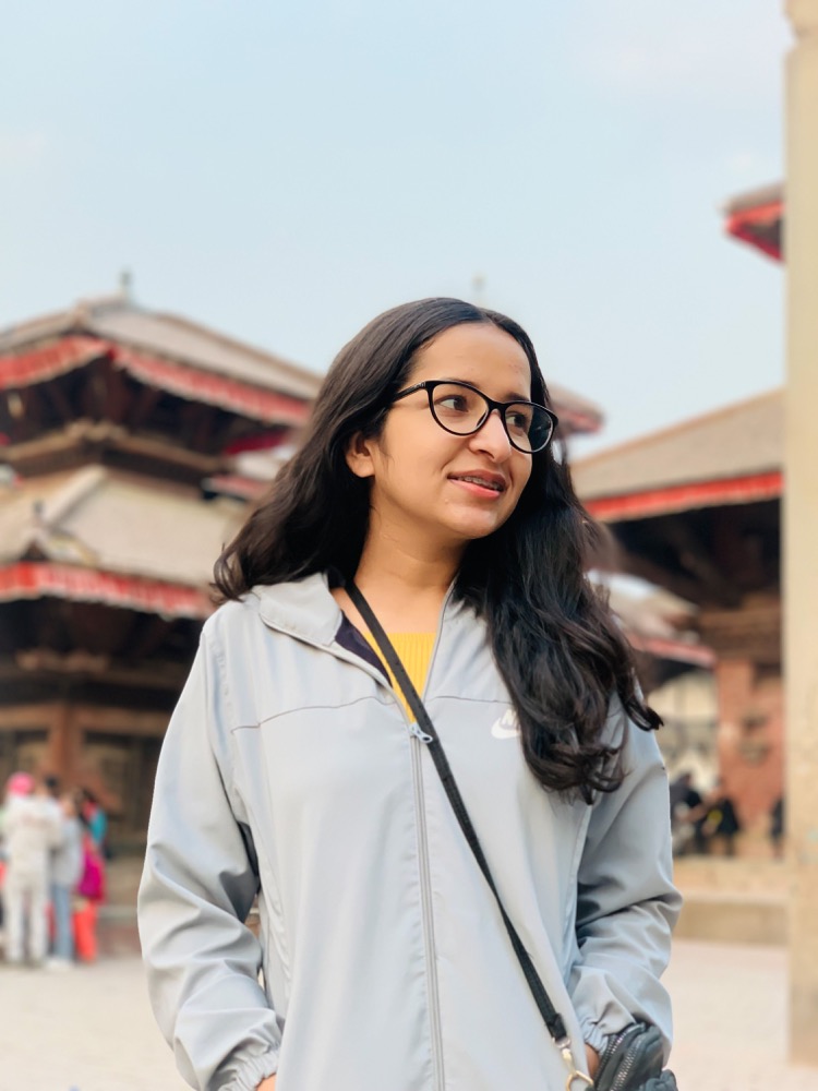 Zara wearing glasses outdoors